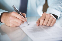 Businessman is signing a contract, business contract details